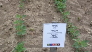 A sign with an herbicide list on a test plot of soybeans