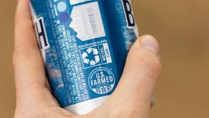 Hand holding Busch Light beer can with U.S. Farmed seal